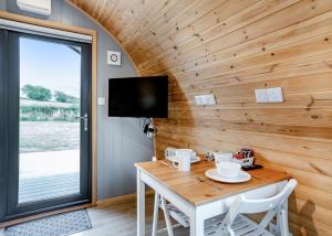 a dining room with a table and a tv at South View Retreat in Carlton