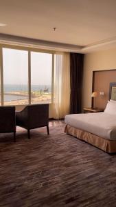 a hotel room with a bed and a view of the beach at Beach Inn in Al Qunfudhah