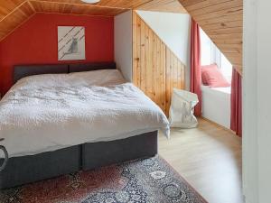 a bedroom with a bed with a red wall at Tigh An Dun in Luib