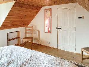 a bedroom with a bed and a wooden ceiling at Tigh An Dun in Luib