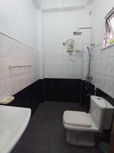 a bathroom with a toilet and a sink at 39 House Weligama in Weligama