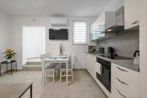 a kitchen with a table and a dining room at Gasparevic Apartments in Rovinj