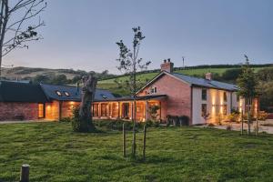 a large brick house with a lot of windows at Haymill Retreat in Trefeglwys