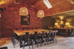 a conference room with a wooden table and chairs at Haymill Retreat in Trefeglwys