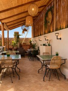 a patio with tables and chairs in a restaurant at Riad Amya & Spa in Marrakesh