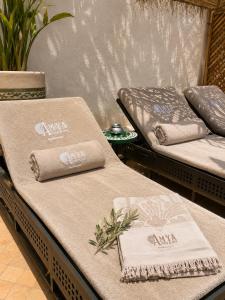 a couple of beds with towels on top of them at Riad Amya & Spa in Marrakesh +80 photos