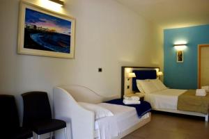 a hotel room with two beds and a chair at Tenuta Espada Gallipoli in Gallipoli +50 photos