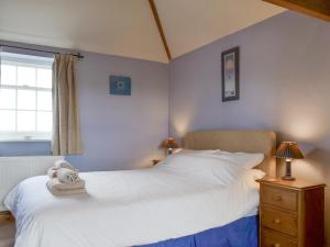 a bedroom with two white beds and a window at Cass Lodge in Huby +12 photos