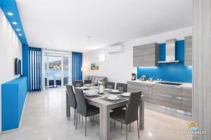a kitchen and dining room with a table and chairs at The Terraces Seafront Getaway Malta 3 Bedroom Apartment in St. Paul's Bay