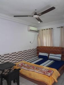 a bedroom with a large bed and a table at St Nicholas Guest Inn in Galadima