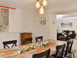 a dining room with a table with flowers on it at Riverside Cottage - Uk32405 in Stanhope