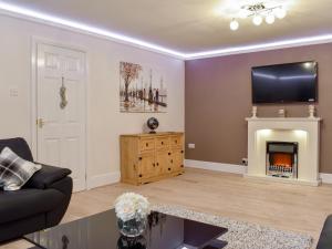 a living room with a couch and a fireplace at Riverside Cottage - Uk32405 in Stanhope