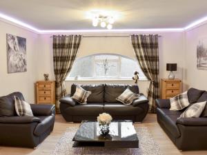 a living room with a couch and a table at Riverside Cottage - Uk32405 in Stanhope