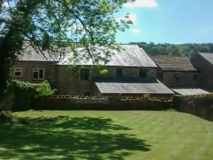 an old stone house with a large yard at Riverside Cottage - Uk32405 in Stanhope +14 photos