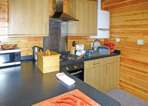 a kitchen with a stove and a counter top at Goodiford Mill Lakes in Kentisbeare