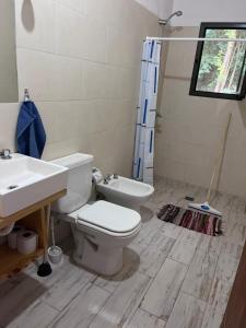a bathroom with a toilet and a sink at Cabañas Nido Escondido in Villa Ciudad Parque +11 photos