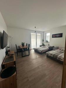 a room with two beds and a table with a dining room at APARTAMENT Z TARASEM STELLA in Sanok