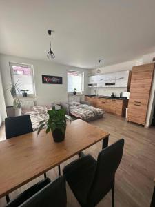 a living room with a table and a couch at APARTAMENT Z TARASEM STELLA in Sanok