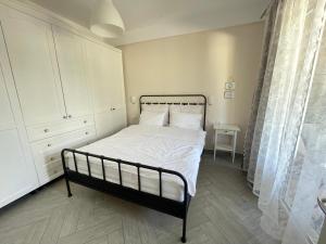a bedroom with a bed with white sheets and white pillows at Renissa's Beach Suite in Vlorë