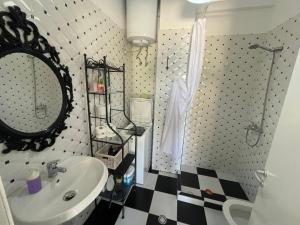 a bathroom with a sink and a mirror at Renissa's Beach Suite in Vlorë +51 photos