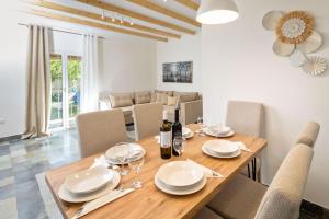 a dining room with a wooden table and chairs at Pavlos & Sofia Harmony Villa with Private Pool in Corfu +85 photos