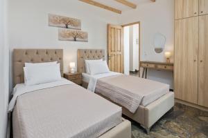 a hotel room with two beds and a desk at Pavlos & Sofia Harmony Villa with Private Pool in Corfu