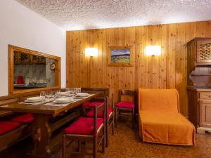 a dining room with a table and chairs and wooden walls at Apartment Casa Rossa by Interhome in Madesimo