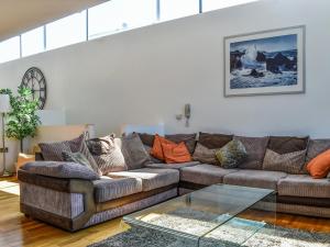 a living room with a couch and a glass table at The Balcony in Westward Ho
