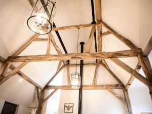 a chandelier hangs from the ceiling of a barn at Olivers Barn - Uk42081 in East Garston
