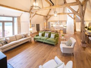 a living room with two couches and a table at Olivers Barn - Uk42081 in East Garston