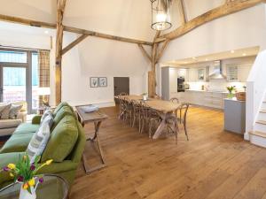 a living room with a green couch and a table at Olivers Barn - Uk42081 in East Garston +27 photos