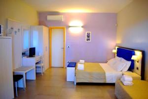a hotel room with a bed and a desk at Tenuta Espada Gallipoli in Gallipoli
