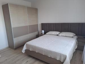 a bedroom with a large bed and a wooden floor at MarVi home in Ruse