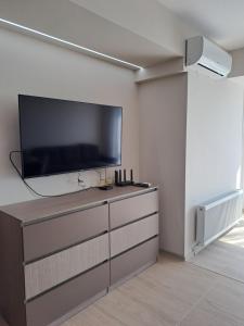 a living room with a flat screen tv on a wall at MarVi home in Ruse