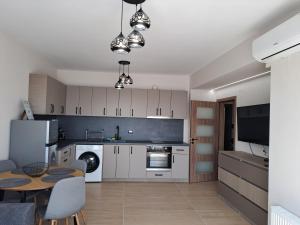 a kitchen with white cabinets and a table in a room at MarVi home in Ruse