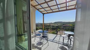 a balcony with a table and chairs on a patio at MarEden Sicily Room , Relax e Bonsai in Favara