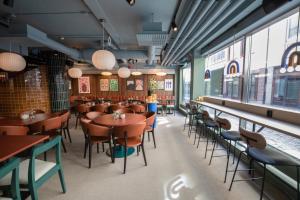 a restaurant with tables and chairs and windows at Comfort Hotel City in Gothenburg