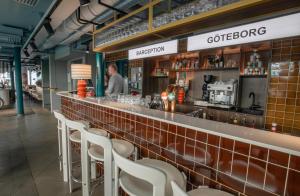 a man standing at a bar in a restaurant at Comfort Hotel City in Gothenburg