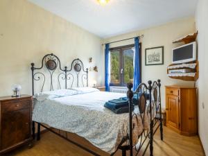 a bedroom with a bed and a window at Apartment Casa Cavalieri by Interhome in Valdisotto