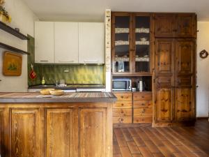 a kitchen with wooden cabinets and a counter top at Apartment Casa Cavalieri by Interhome in Valdisotto +35 photos