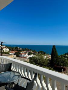 a balcony with a table and chairs and the ocean at Apartments Adriatik in Ulcinj