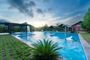 a swimming pool in the yard of a house at KINGS RESORT DANDELI in Dandeli
