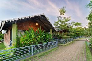 a building with a fence and plants in front of it at KINGS RESORT DANDELI in Dandeli