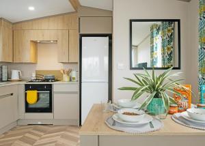 a kitchen with a table with dishes on it at Trossachs Holiday Park in Gartmore