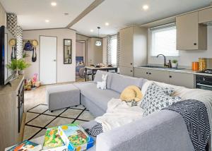a living room with a couch and a kitchen at Trossachs Holiday Park in Gartmore +12 photos