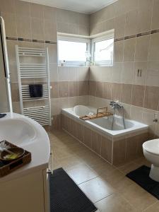 a bathroom with a tub and a toilet and a sink at La Vie est Belle chambre d hôte in Verviers +21 photos