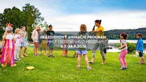 a group of children standing in a field holding a banner at Amenity Hotel & Resort Lipno in Lipno nad Vltavou