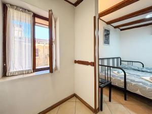 a bedroom with a bed and a window at Studio Piccolo Mondo by Interhome in Lovran