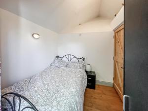 a bedroom with a bed in a room at Fronfanol - Uk49776 in Llanfair Talhaiarn