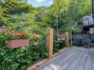 a wooden deck with potted plants and flowers at Fronfanol - Uk49776 in Llanfair Talhaiarn +6 photos